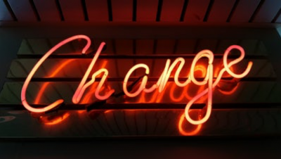 A picture of a sign lit up with the word Change